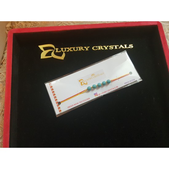 CRYSTAL Rakhi With Turquoise CRYSTAL Beads with Golden charm Beads in Thread