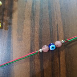 STRAWBERRY QUARTZ CRYSTAL RAKHI WITH EVIL EYE 