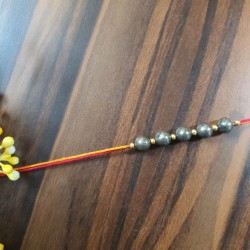 CRYSTAL Rakhi With Pyrite CRYSTAL Beads with Golden Charms Beads in Thread