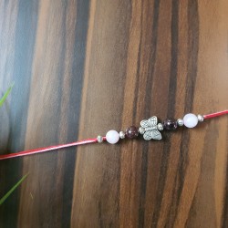 CRYSTAL Rakhi With Rose Quartz and Garnet with Silver Charms in Thread