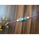 CRYSTAL Rakhi  Rose Quartz with Turquoise with Silver Charms in Thread