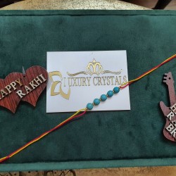 CRYSTAL Rakhi With Turquoise CRYSTAL Beads with Golden charm Beads in Thread