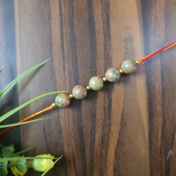 CRYSTAL Rakhi With Unakite CRYSTAL Beads with Golden Charm beads in Thread